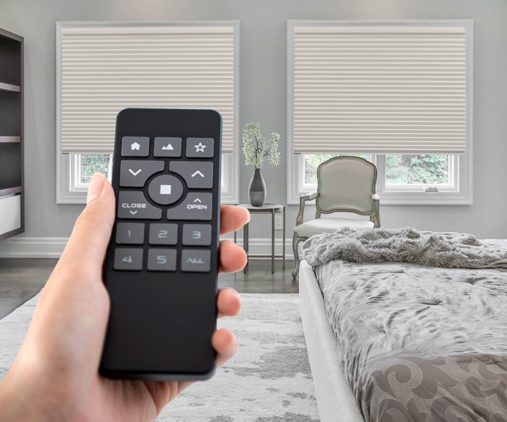 hand with a remote control for honeycomb shades by norman