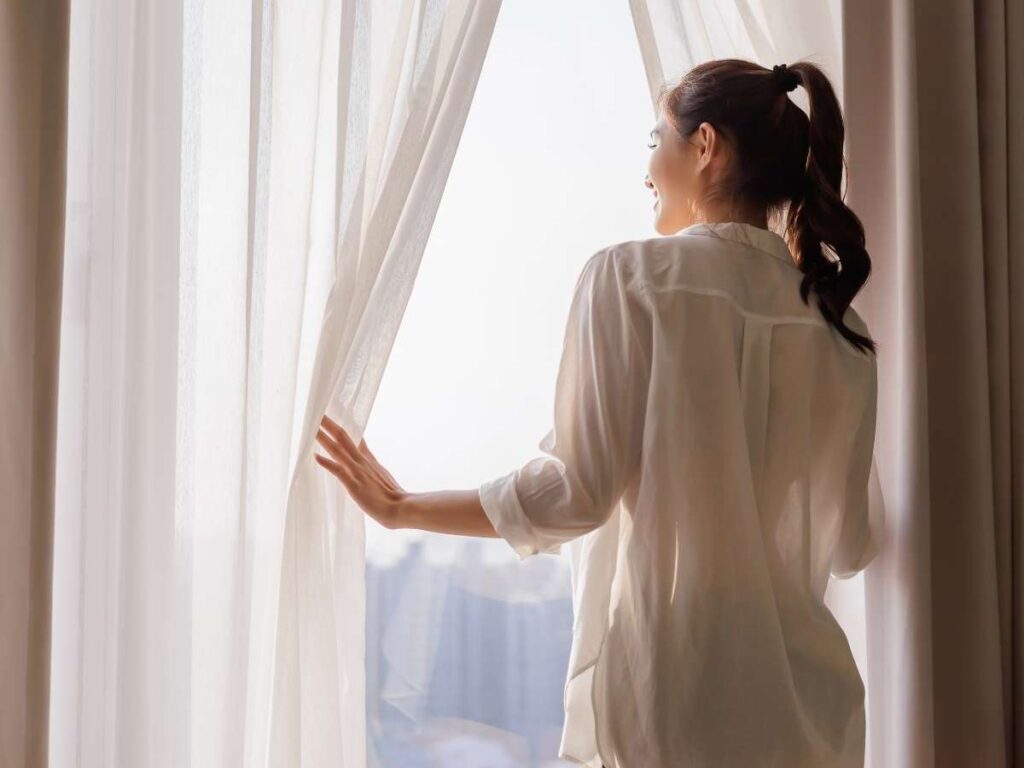 Elegant drapes hanging by a window, adding a touch of sophistication to the room.