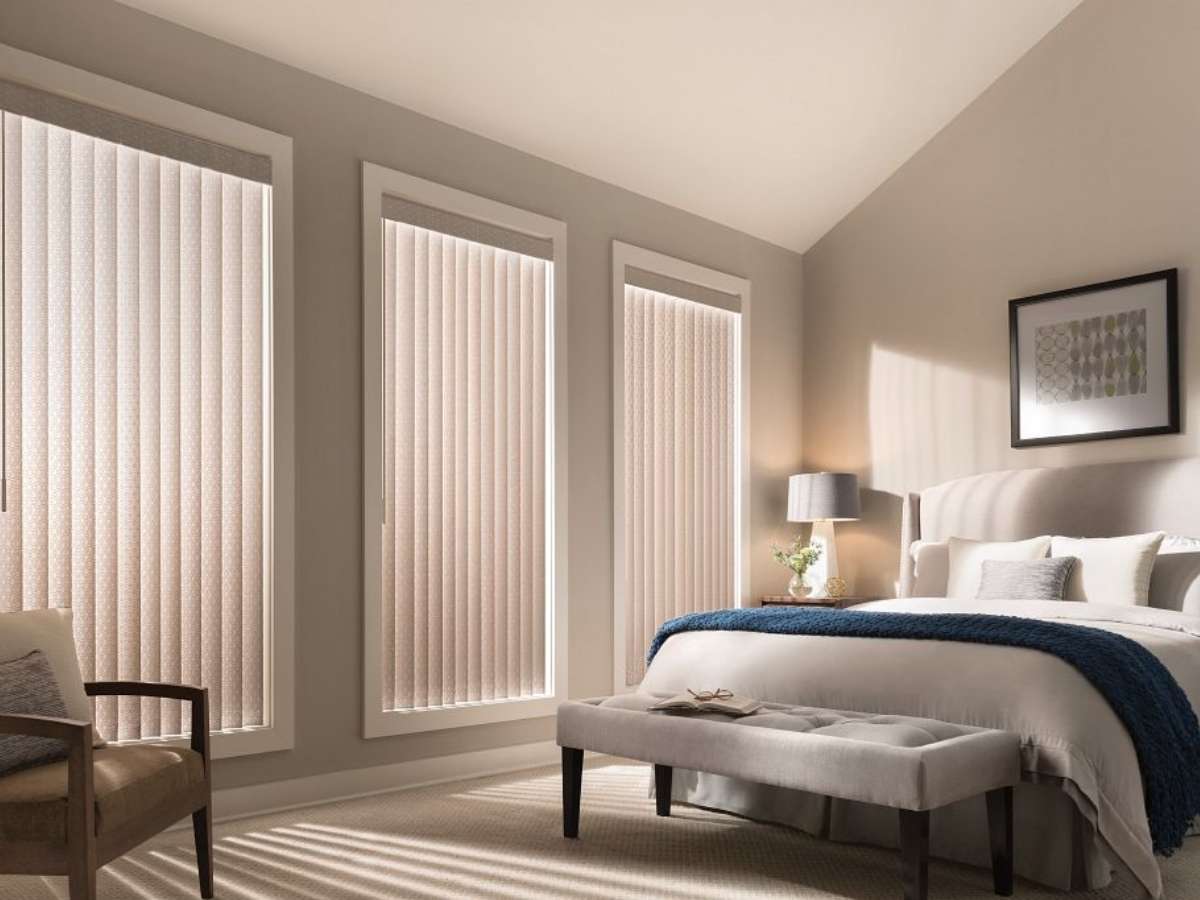 Custom Graber vertical blinds with light-filtering panels in spacious bedroom