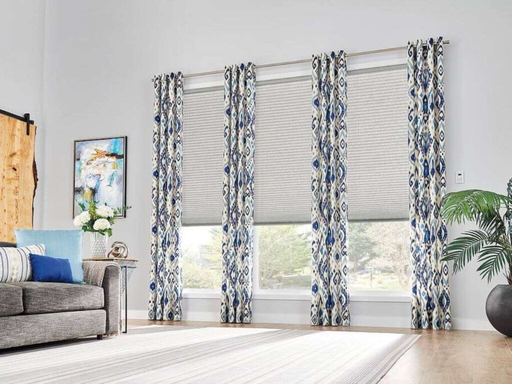 Create a Cozy Retreat: Layer Cellular Shades with Curtains 2 Cellular Shades with Curtains in Living Room Graber